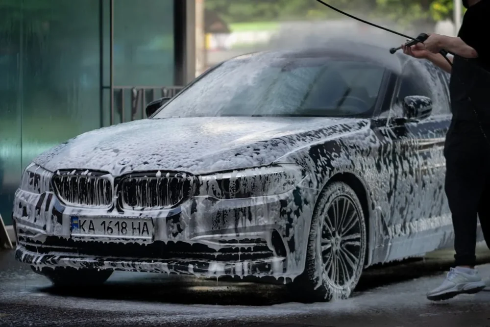 BMW covered in thick white foam during a hand wash